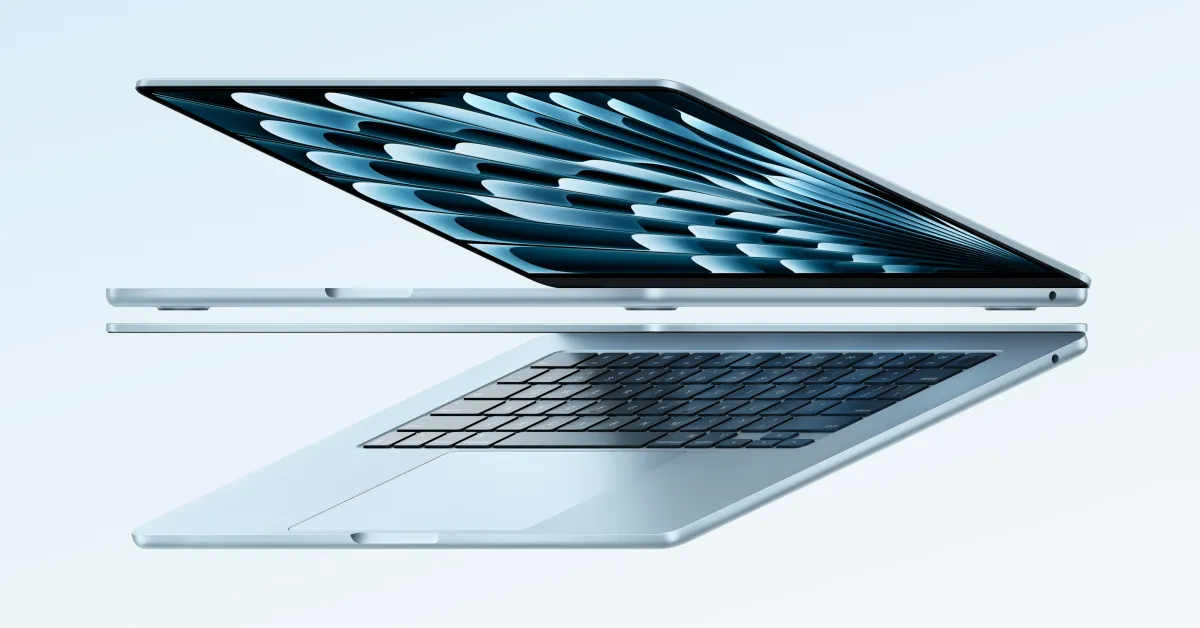 A person holding a MacBook with a Prime Day sale banner in the background.