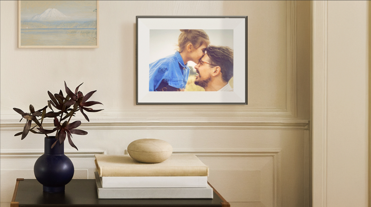 Aura Ink e-ink photo frame displaying a black and white photograph with a matte finish, resembling a traditional print.