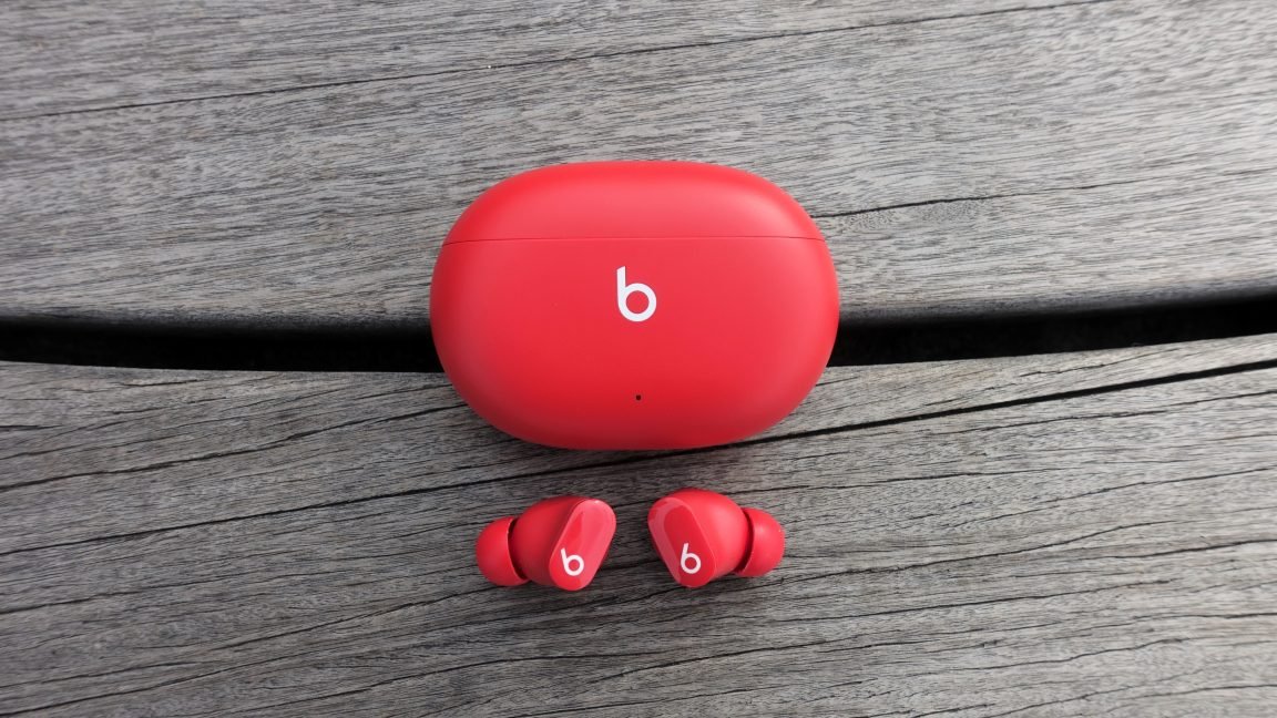 Beats Studio Buds with a subtle security shield icon overlay