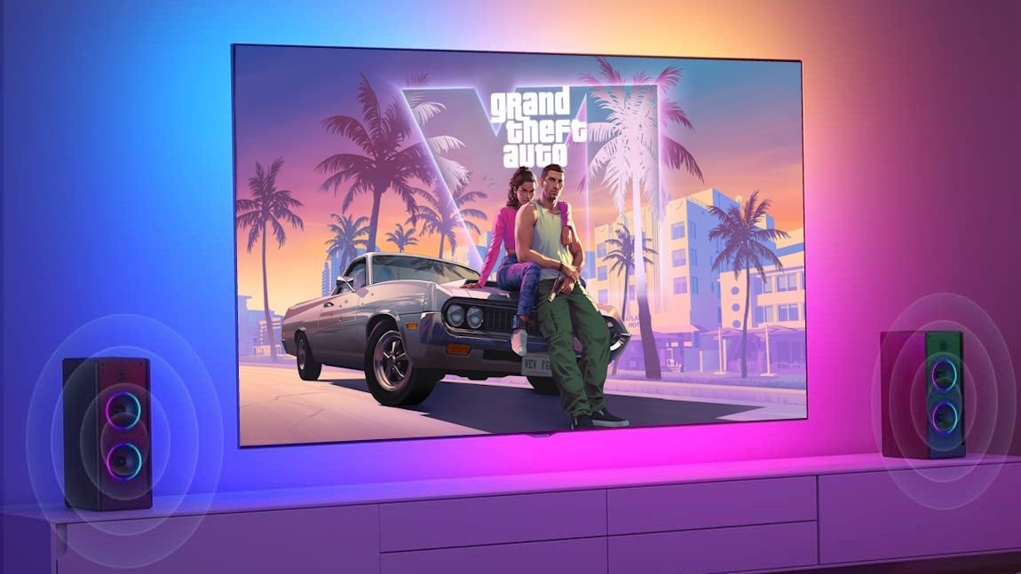 Ambient RGB LED strip lights installed behind a TV, casting a colorful glow on the wall, perfect for a GTA VI-themed living room setup.