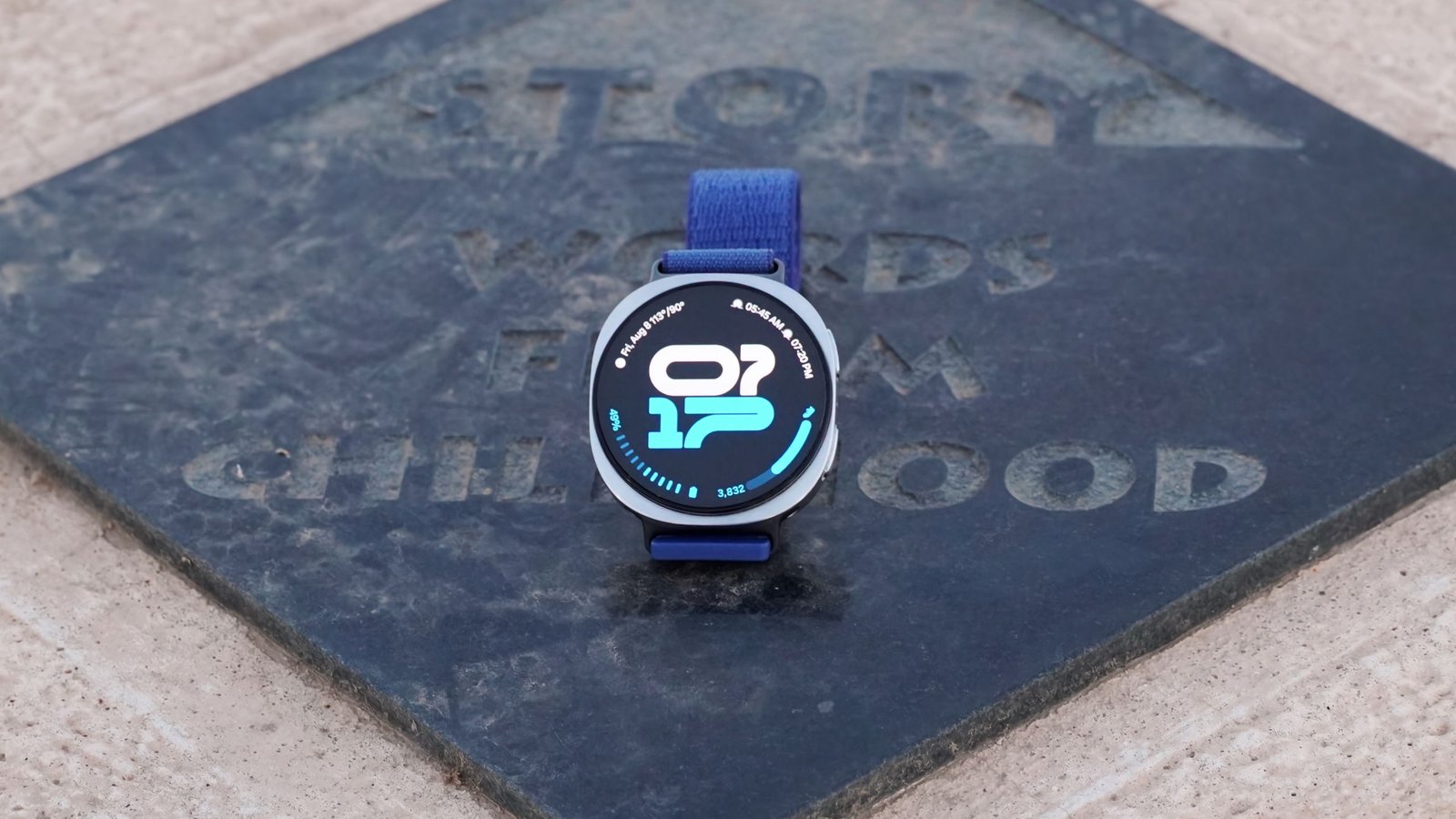 Samsung Galaxy Watch 8 with a close-up of its screen showing a notification.
