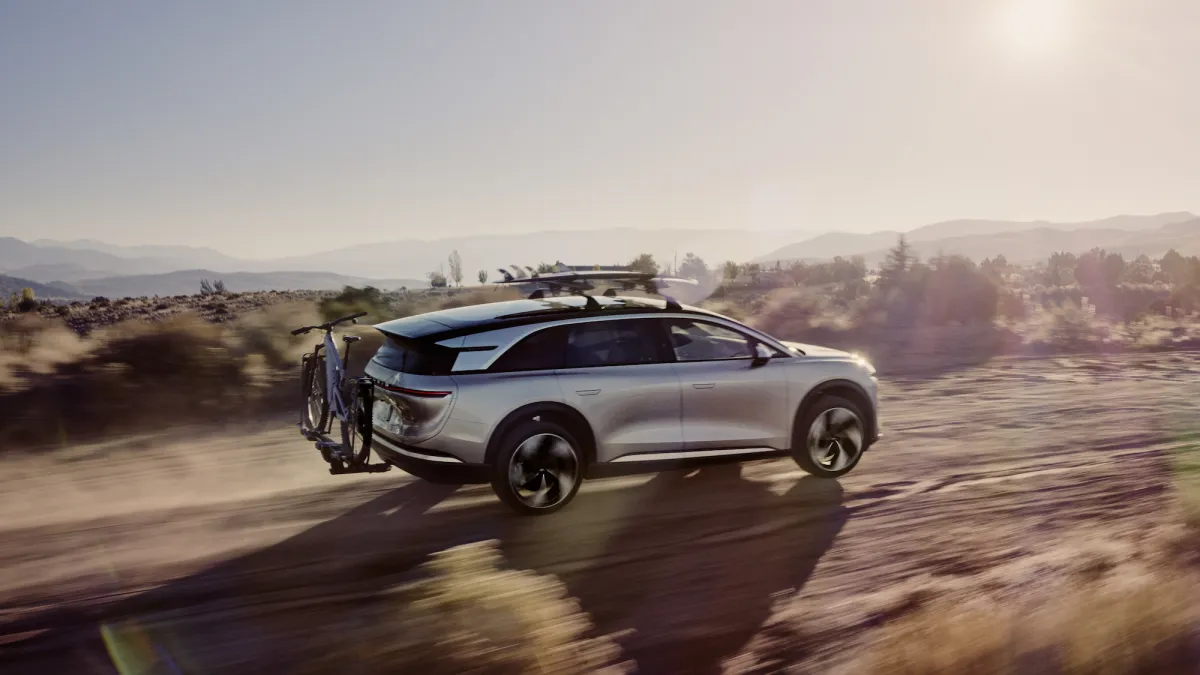 Lucid Motors factory with text overlay indicating layoffs