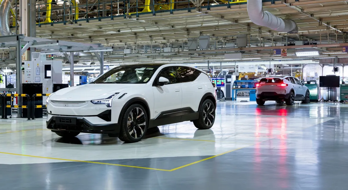 Polestar electric vehicle parked in a showroom, with a Volvo logo subtly visible in the background.