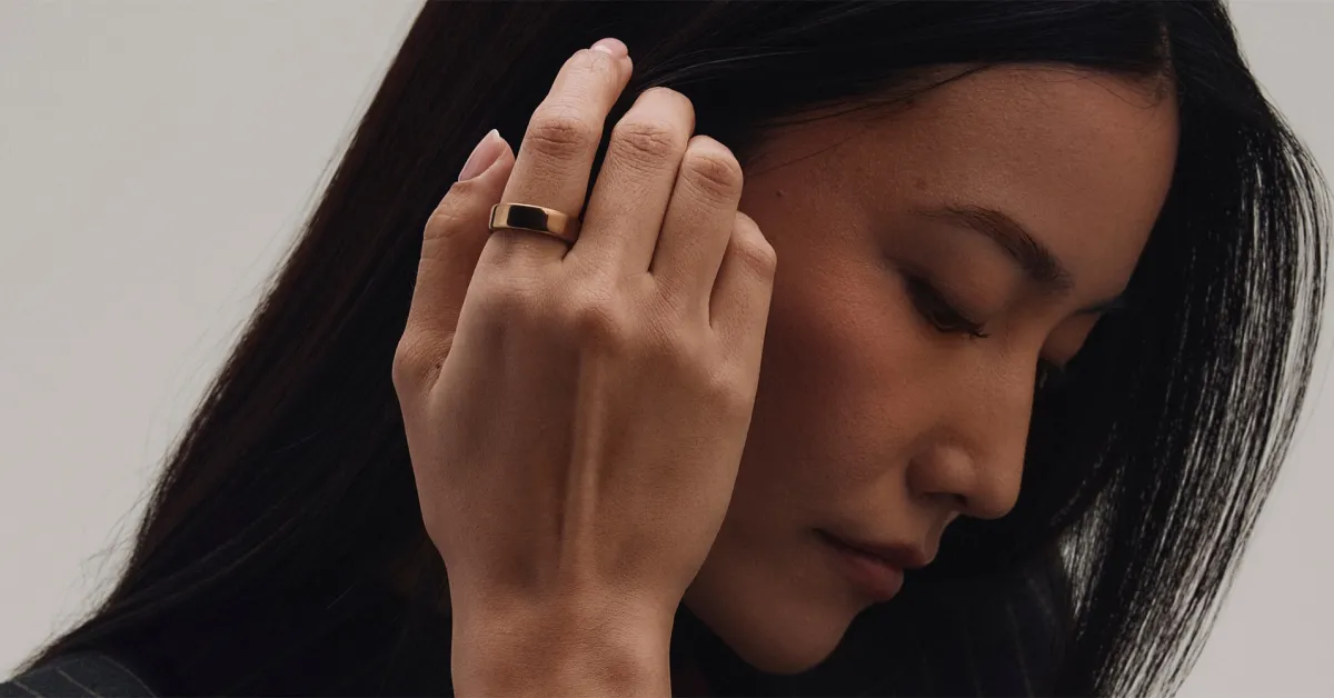 Oura Ring 5 on a finger, showcasing its sleek design and health tracking capabilities.