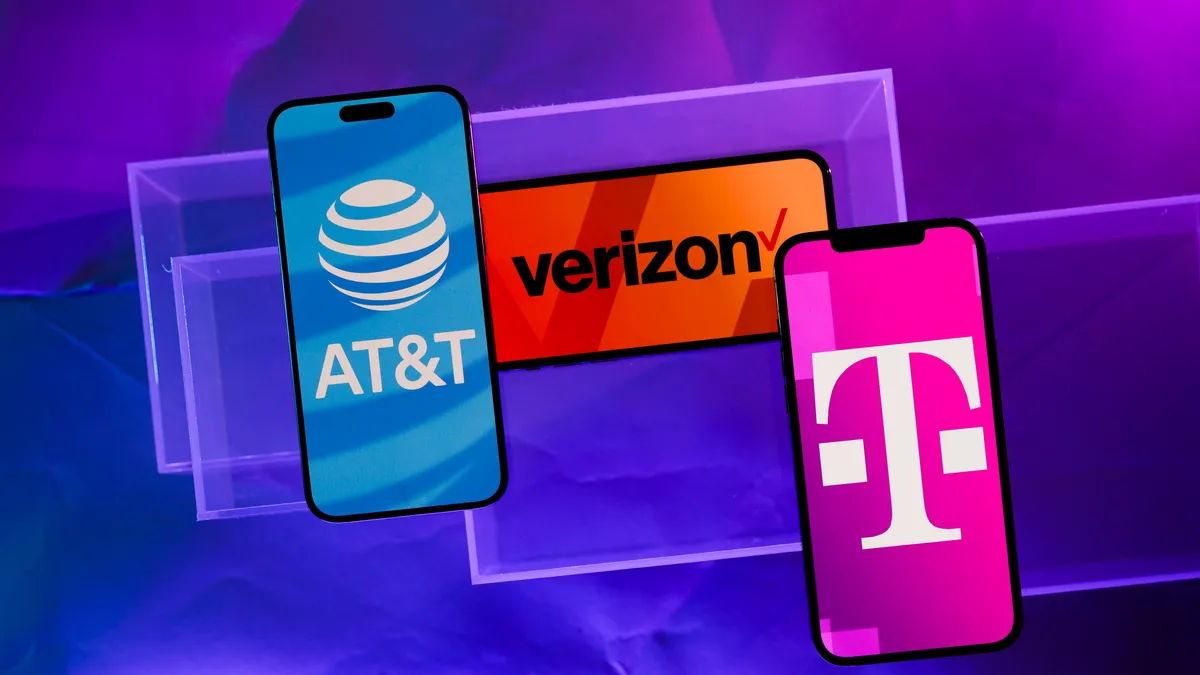 A diverse family smiling and looking at their smartphones, representing the best family phone plans for 2026.