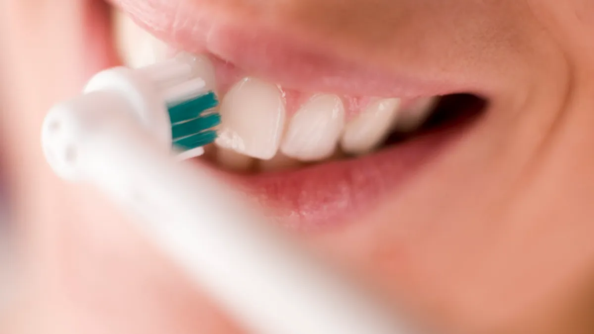 Close-up of a modern electric toothbrush with a sleek design, showcasing its advanced features for optimal oral hygiene in 2026.