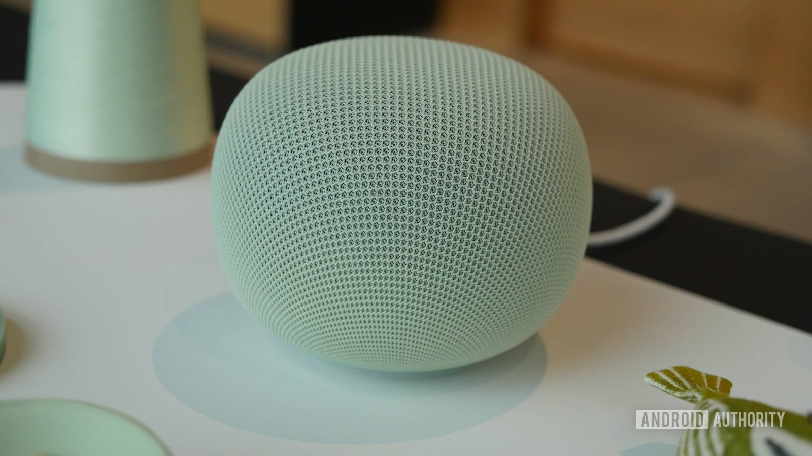 Google Home speaker with its permanently attached power cable visible.