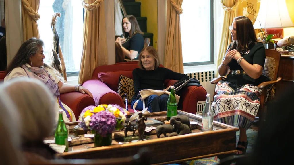 Gloria Steinem hosts a salon in her living room discussing parental leave, leadership, and democracy.