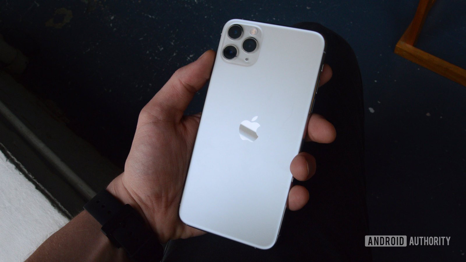 Close-up of an older iPhone model displaying a cracked screen, symbolizing a security vulnerability.