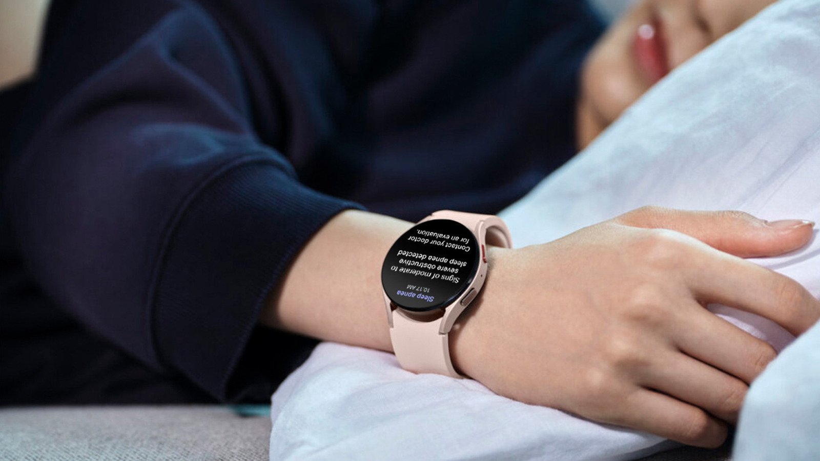 A person sleeping peacefully with a smartwatch on their wrist, illustrating the concept of a smartwatch detecting sleep apnea.