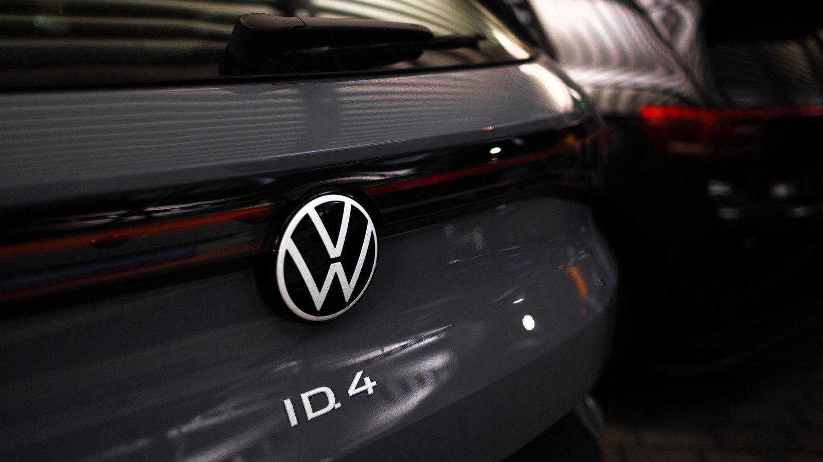 Volkswagen logo with a red 'X' over it, symbolizing job cuts and plant closures.