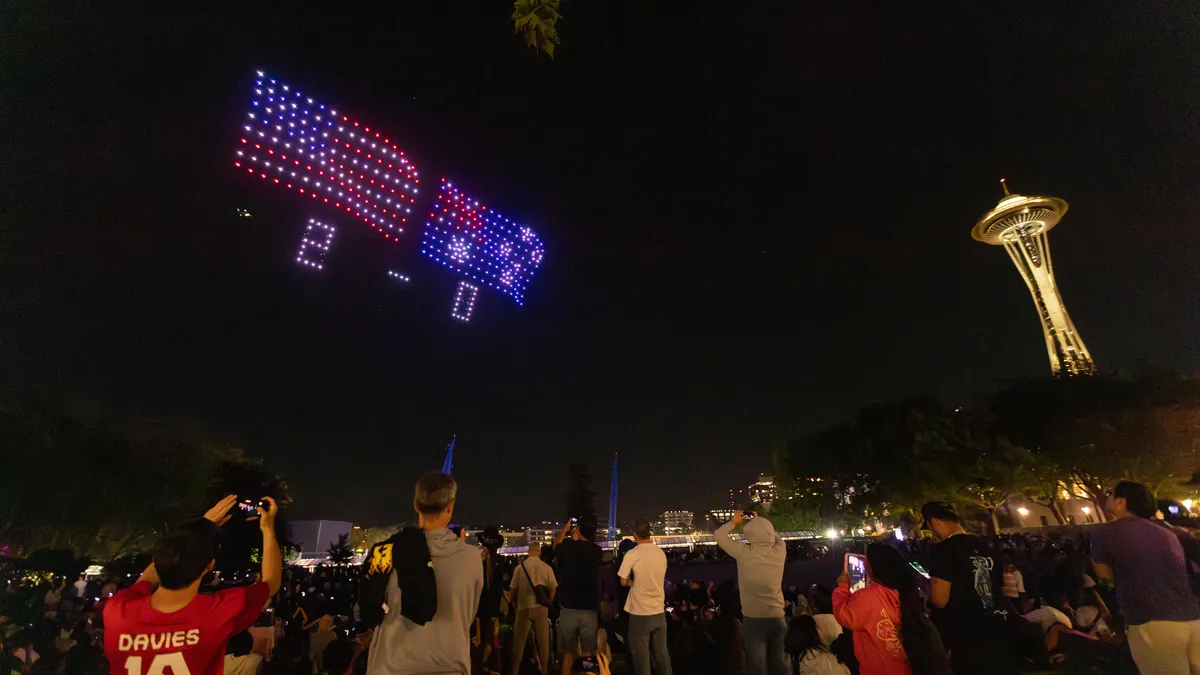 Seattle World Cup drone scoreboard illuminating the night sky with vibrant lights.