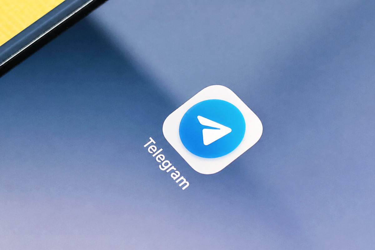 People using VPNs on their phones and computers, symbolizing a rush for virtual private networks due to the potential Telegram ban in India.