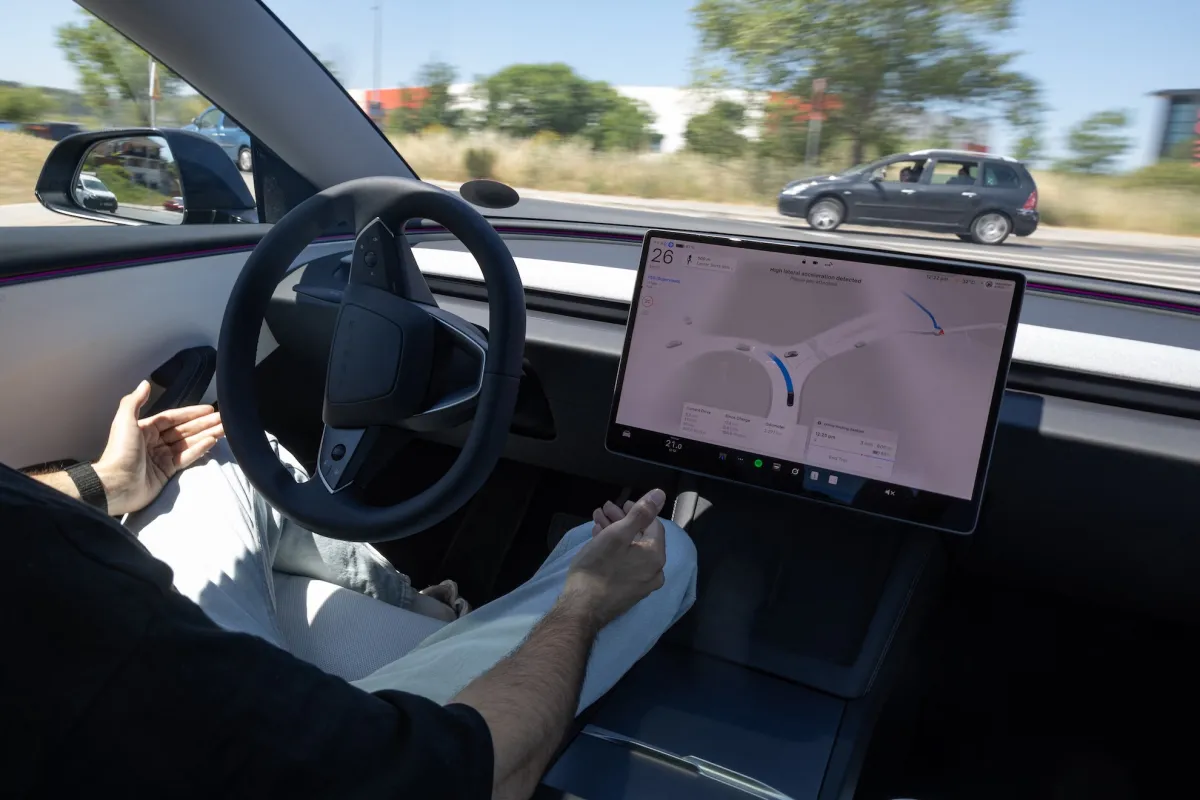 Tesla vehicle navigating a city street with its Full Self-Driving (FSD) system engaged, showcasing its advanced sensor suite and visualization.
