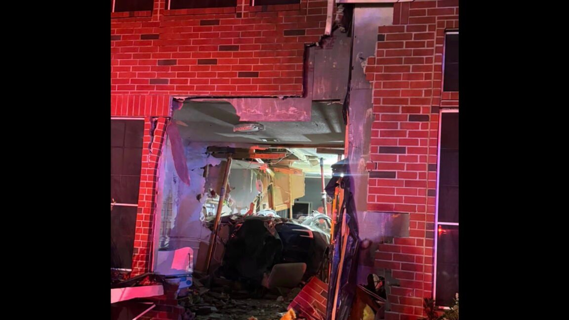 Police tape surrounds a damaged home in Texas after a Tesla on Autopilot crashed into it, killing a woman.